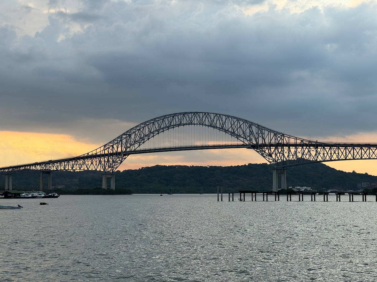 A steel arch bridge above a broad waterway